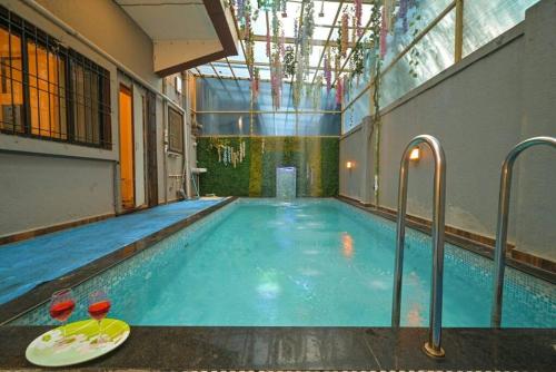 a swimming pool in a building with a swimming pool at RK Villa in Lonavala