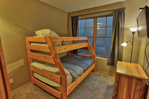 a bunk bed in a room with a window at Corral Hideaway Steps from Downtown in Breckenridge