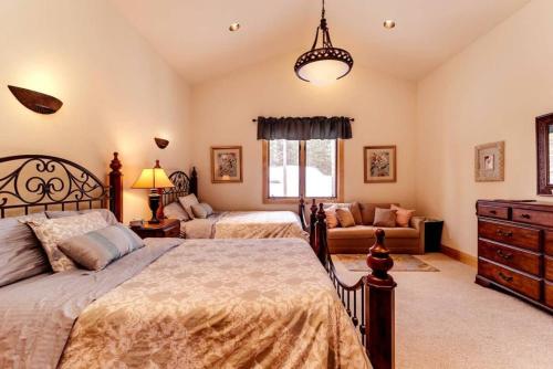 a bedroom with two beds and a couch at Lazy Fox Lodge in National Forest View in Breckenridge
