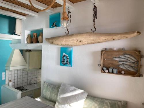 a bedroom with a bed and a surfboard on the wall at Design house on the beach in Rámos