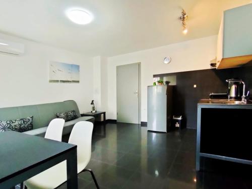 a living room with a couch and a refrigerator at Rafael Apartments in Medulin