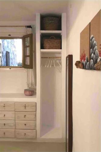 a kitchen with a dresser and a window at Design house on the beach in Rámos