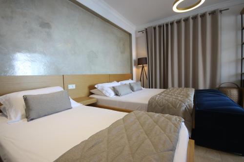 a hotel room with two beds and a window at ARXONTIKO in Himare