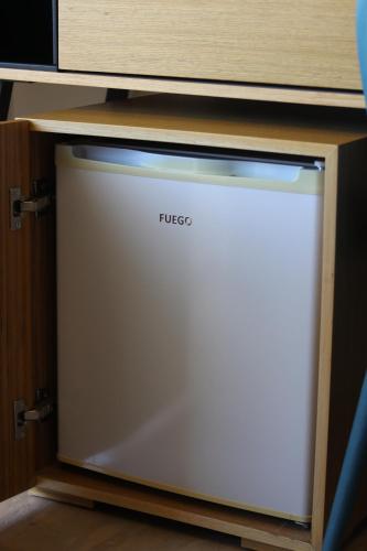 a white dishwasher sitting under a cabinet at ARXONTIKO in Himare