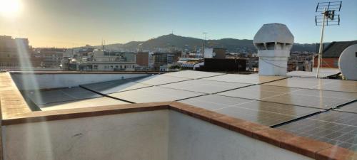 a rooftop with a view of a city at Feel at Sants Apartments in Barcelona