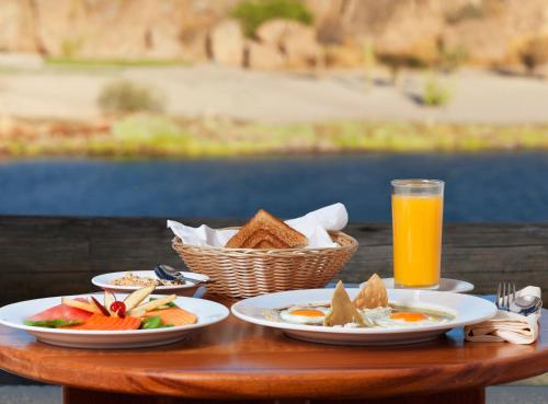 a table with plates of food and a glass of orange juice at Loreto Bay Golf & Sea at Baja in Loreto
