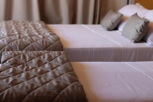 two beds sitting next to each other in a room at ARXONTIKO in Himare