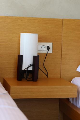 a desk with a lamp and a light in a bedroom at ARXONTIKO in Himare