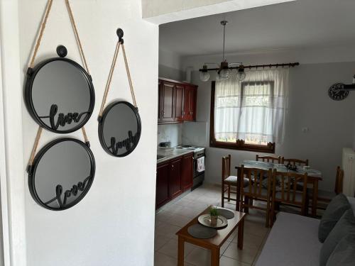 a kitchen and a living room with two round mirrors at Paradise of Meteora B in Kastrákion