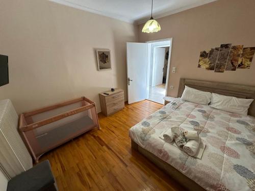 a bedroom with a bed and a wooden floor at Paradise of Meteora B in Kastrákion