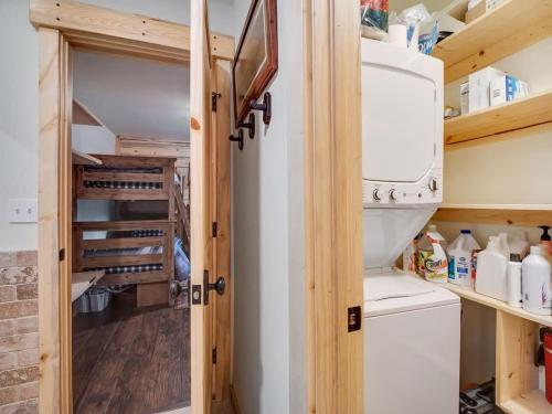 a small kitchen with a washer and dryer in a tiny house at Cozy 2BR Condo Near Peak 8 and Town with Hot Tub Access in Breckenridge