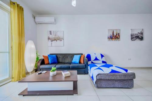 a living room with a couch and a coffee table at Super Location, St Julians, 2 Bedroom, Paceville APT 7 by Vaganza in St Julian's