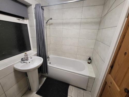 a bathroom with a sink and a tub and a toilet at Stay Sleep Rest - Santuary in Hull