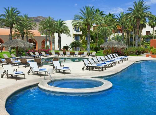 a swimming pool with lounge chairs and a resort at Loreto Bay Golf & Sea at Baja in Loreto