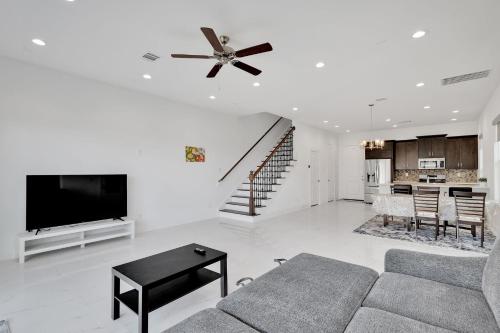 a living room with a couch and a ceiling fan at Centrally Located TX Medical Center - Walk to NRG! townhouse in Houston