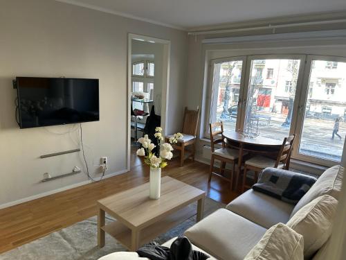 a living room with a vase of flowers on a table at CITY Centrum in Gothenburg