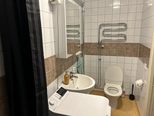 a small bathroom with a toilet and a sink at CITY Centrum in Gothenburg