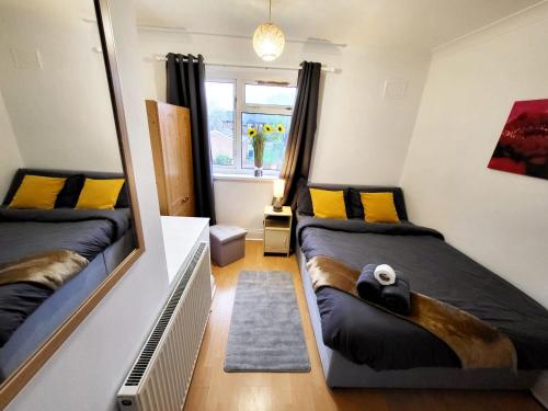 a bedroom with two beds and a mirror at Stay Sleep Rest - Santuary in Hull