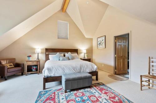 a large bedroom with a bed and a chair at 3 BDR Retreat Cozy Home with Private Hot Tub in Silverthorne
