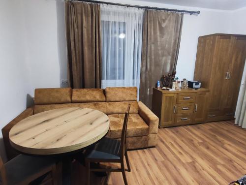 sala de estar con sofá y mesa en U Janka Trzeciego 6 Sauna & Jacuzzi en Oleszyce