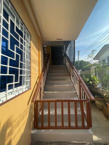 a staircase leading up to a building with a window at Chan One Corner in San Juan