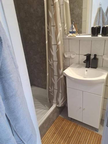 a white bathroom with a shower and a sink at Andi Apartment Szeged Center in Szeged