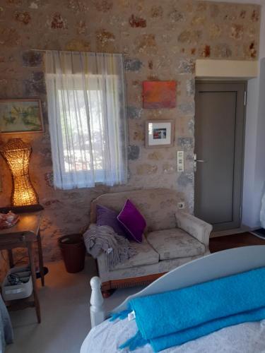 a living room with a couch and a window at Jenny's Greek Villa in Levktron
