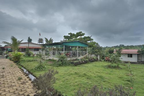 a building with a pavilion in a yard at Sundarbagh farmhouse in Khamshet