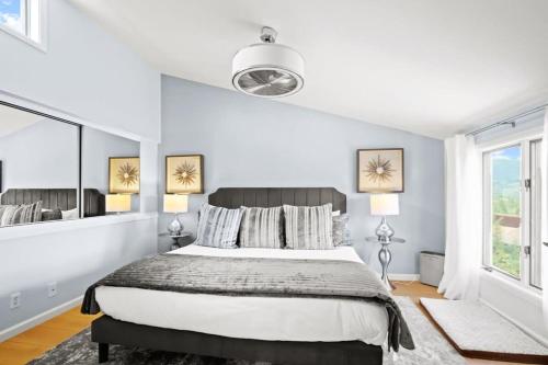 a white bedroom with a bed and a large window at Stunning 3BR central to Breck Keystone Copper in Silverthorne
