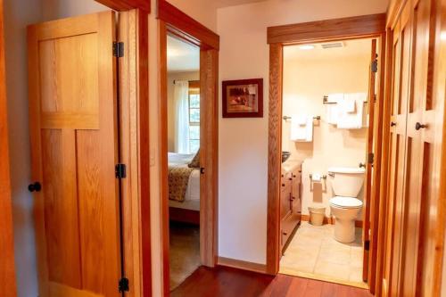 a small bathroom with a toilet and a bedroom at Tranquil 3BR Home Access To Trails and Mtn Views in Blue River