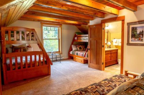 a bedroom with two bunk beds and a bathroom at Tranquil 3BR Home Access To Trails and Mtn Views in Blue River