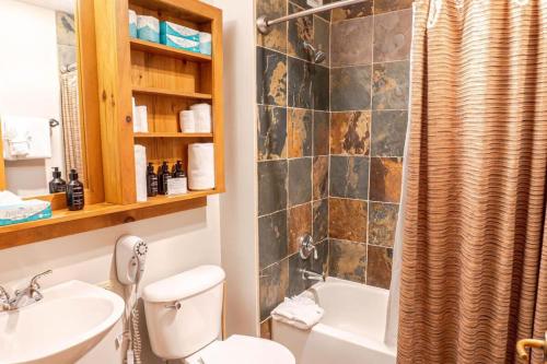 a bathroom with a toilet and a sink and a tub at 2BR Ski In Ski Out Keystone Condo Walk to Slopes in Dillon