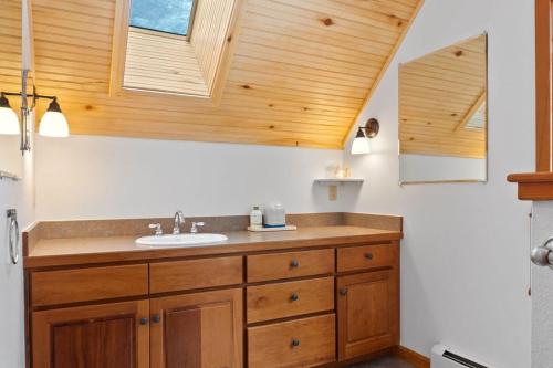 a bathroom with a sink and wooden cabinets at Serene 3BD with Stunning Views and Hot Tub in Breckenridge