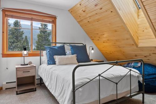 a bedroom with a bed and a wooden ceiling at Serene 3BD with Stunning Views and Hot Tub in Breckenridge