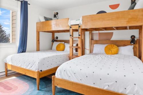 a bedroom with two bunk beds and a window at Stylish 2BR Near Trails and Slopes in Dillon