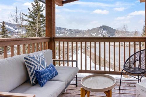 a porch with a couch and a table and chairs at Stylish 2BR Near Trails and Slopes in Dillon