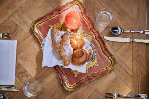 a plate of food with pastries on a table at Palazzo Vecchio Taormina in Taormina