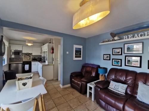 a living room with a couch and a table at Coral Cove Bundoran in Bundoran