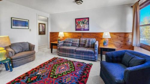 a living room with a couch and a chair at Manorhouse Hideaway in Dillon