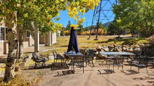 a group of tables and chairs with an umbrella at Manorhouse Hideaway in Dillon