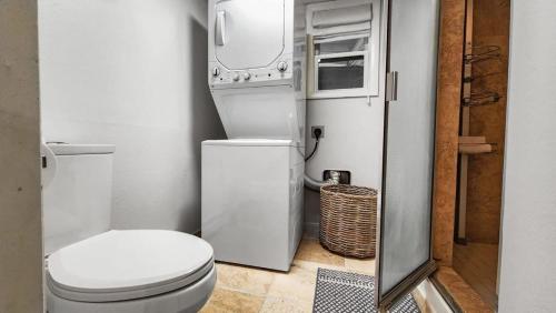 a small bathroom with a toilet and a refrigerator at 2BR Condo in the Heart of Breck in Breckenridge
