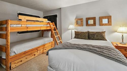 a bedroom with two bunk beds and a ladder at 2BR Condo in the Heart of Breck in Breckenridge