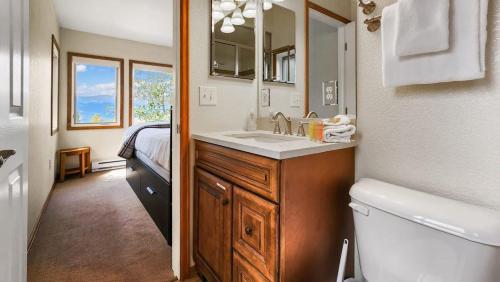 a bathroom with a sink and a toilet and a mirror at Bright Baldy 2BD Near Trailheads in Breckenridge