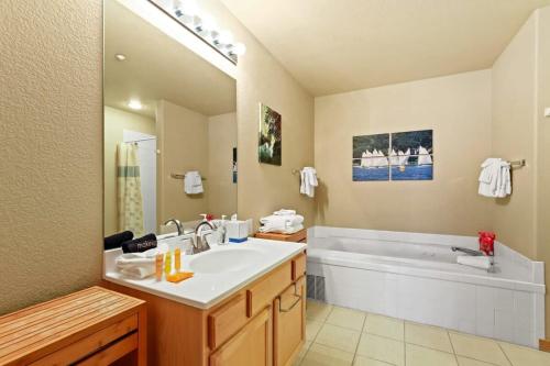 a bathroom with a sink and a bath tub at 2BR Condo - Ideal Hub for Year-Round Fun in Silverthorne