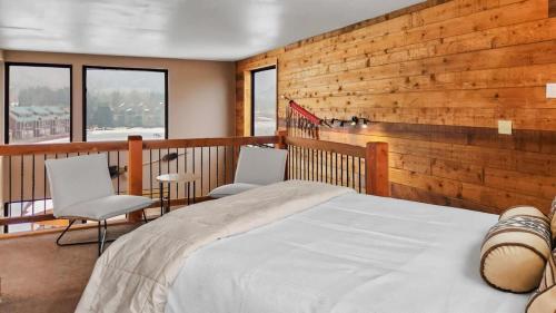 a bedroom with a bed and two chairs at Chic Lakeside 1BR 4-Min to Keystone Resort in Keystone