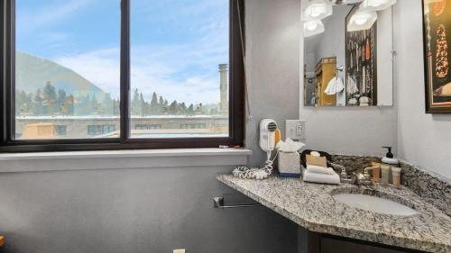 a bathroom with two sinks and a window at Chic Lakeside 1BR 4-Min to Keystone Resort in Keystone