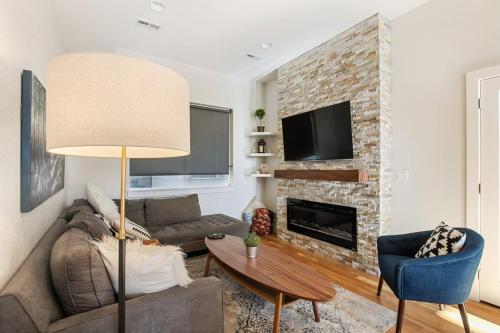 a living room with a couch and a fireplace at 2 BDR Home Roof Deck plus Walk to Broncos and Sloans Lake in Denver