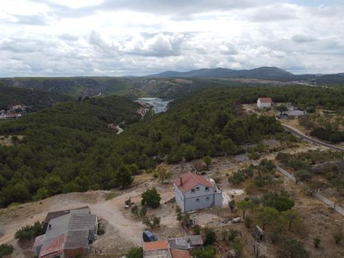 an aerial view of a small white house on a hill at Panorama Studio in Skradin