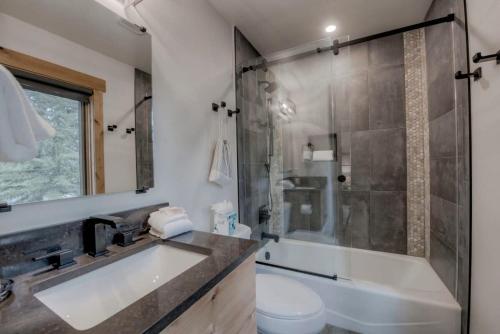 a bathroom with a sink and a shower and a toilet at Ski In Out Townhome with Hot Tub and Lovely Mtn Views in Breckenridge