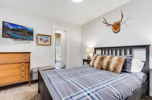a bedroom with a bed and a dresser in it at Gorgeous View in Town Walk to Lifts in Breckenridge